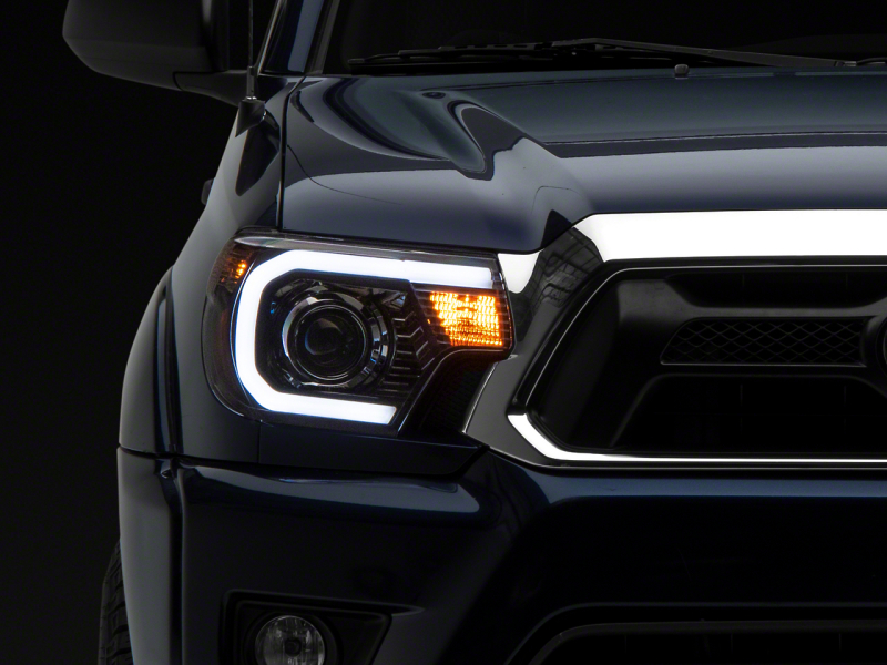 Raxiom for 2012-2015 Toyota Tacoma Axial Projector Headlights w/ SEQL LED Bar- Black Housing (Clear Lens)