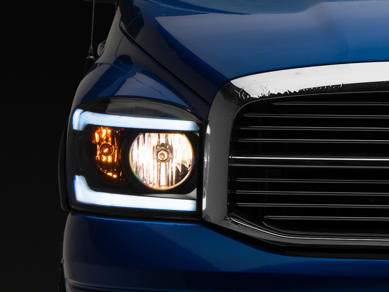 Raxiom for 2006-2009 Dodge RAM 1500/2500/3500 Axial Headlights w/ SEQL LED Bar- Black Housing (Clear Lens)
